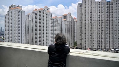 A man looks at apartment buildings in Jakarta on March, 7 2024. (Photo by BAY ISMOYO / AFP) (AFP) A man looks at apartment buildings in Jakarta on March, 7 2024. (Photo by BAY ISMOYO / AFP) (AFP)
