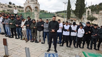 Palestinian Muslims perform the Friday Noon prayer on a street in east Jerusalem (AFP)
