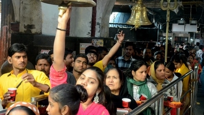 Devotees wait in queue at the Baba Anandeshwar Temple to offer prayers to Lord Shiva on Maha Shivratri in Parmat, Kanpur. (PTI)