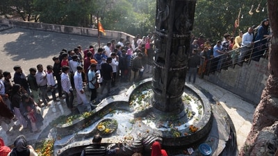 Devotees throng Gufa Wala Mandir in Preet Vihar, East Delhi, to offer auspicious items to the large Shiva Linga on the occasion of Maha Shivratri.&nbsp; (PTI)
