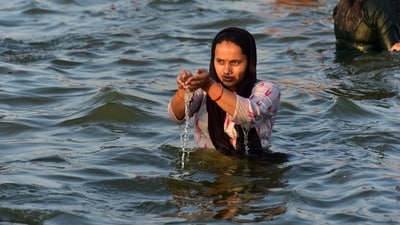 &nbsp;A devotee offers prayer after taking a holy dip in the River Ganga on Maha Shivratri at Sangam in Prayagraj. (PTI)