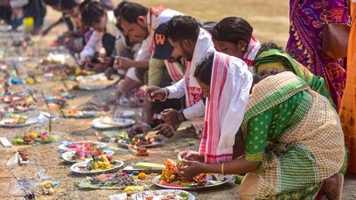 Devotees prepare a 'puja thali' with offerings at the Maha Mrityunjay Temple during the Maha Shivratri festival in Nagaon distrit, Assam. (PTI)