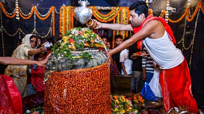 Priests perform 'Jal Abhishek' of Lord Shiva at the Mahabhairab Temple on the Mahashivratri festival at Tezpur in Sonitpur district, Assam. (PTI)