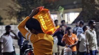 People stand in a queue with water cans to get drinking water at Jnana Jyothi Nagar in Bengaluru. (PTI) People stand in a queue with water cans to get drinking water at Jnana Jyothi Nagar in Bengaluru. (PTI)