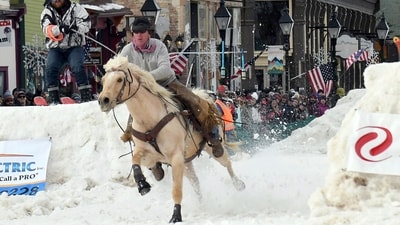 Skijoring draws its name from the Norwegian word skikjoring, meaning "ski driving." It started as a practical mode of transportation in Scandinavia and became popular in the Alps around 1900. Today's sport features horses at full gallop towing skiers by rope over jumps and around obstacles as they try to lance suspended hoops with a baton, typically a ski pole that's cut in half. (AP Photo/Thomas Peipert) Skijoring draws its name from the Norwegian word skikjoring, meaning "ski driving." It started as a practical mode of transportation in Scandinavia and became popular in the Alps around 1900. Today's sport features horses at full gallop towing skiers by rope over jumps and around obstacles as they try to lance suspended hoops with a baton, typically a ski pole that's cut in half. (AP Photo/Thomas Peipert)