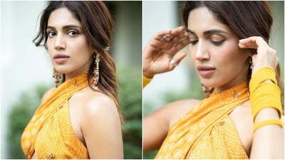 Bhumi accessorised the Bandhani ensemble with yellow bangles, a gold armlet, rings, a kamar challa, and ornate gold jhumkis decked with hair ornaments. Lastly, she chose winged eyeliner, shimmering brown eye shadow, mauve lip shade, mascara on the lashes, feathered brows, and centre-parted half-up, half-down hairdo, and rouge on the cheekbones.&nbsp; (Instagram)
