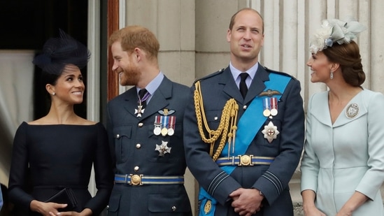 FILE - Britain's Queen Elizabeth II, and from left, Meghan the Duchess of Sussex, Prince Harry, Prince William and Kate the Duchess of Cambridge watch a flypast of Royal Air Force aircraft pass over Buckingham Palace in London, (AP)