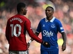 Everton's English defender #18 Ashley Young (R) gestures to Manchester United's English striker #10 Marcus Rashford (L) during the English Premier League football match
