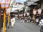 People walk along a street in Gion area, Kyoto, western Japan. Japan’s ancient capital of Kyoto, long a popular destination for tourists, will be closing off some private-property alleys in its famous geisha district, as complaints grow about misbehaving visitors. 