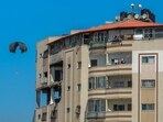 A parachute falls behind a building as aid parcels are airdropped over the northern Gaza Strip on March 8, 2024, amid the ongoing conflict between Israel and the Hamas movement. 