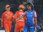 Mumbai Indians batter Harmanpreet Kaur exchanges greetings with Gujarat Giants players Mumbai Indians batter Harmanpreet Kaur exchanges greetings with Gujarat Giants players