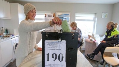 An Islander, Maria McSweeney casts her ballot inside the polling station (AFP) An Islander, Maria McSweeney casts her ballot inside the polling station (AFP)