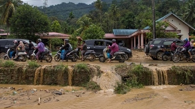 Motorists drive through a muddy road following flash flooding in Pesisir Selatan Regency in West Sumatra on March 9. (AFP) Motorists drive through a muddy road following flash flooding in Pesisir Selatan Regency in West Sumatra on March 9. (AFP)