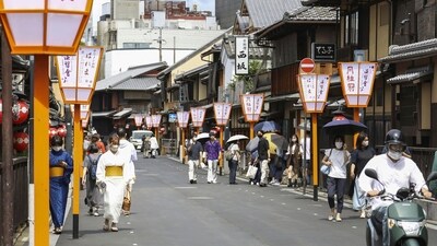 People walk along a street in Gion area, Kyoto, western Japan. Japan’s ancient capital of Kyoto, long a popular destination for tourists, will be closing off some private-property alleys in its famous geisha district, as complaints grow about misbehaving visitors. (Photo by Kyodo News via AP) People walk along a street in Gion area, Kyoto, western Japan. Japan’s ancient capital of Kyoto, long a popular destination for tourists, will be closing off some private-property alleys in its famous geisha district, as complaints grow about misbehaving visitors. (Photo by Kyodo News via AP)