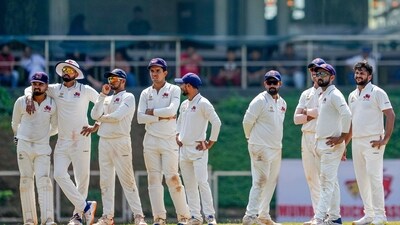 Players of Mumbai look at the big screen during a DRS appeal on the first day of a Ranji Trophy semi-final cricket match between Tamil Nadu and Mumbai (PTI) Players of Mumbai look at the big screen during a DRS appeal on the first day of a Ranji Trophy semi-final cricket match between Tamil Nadu and Mumbai (PTI)