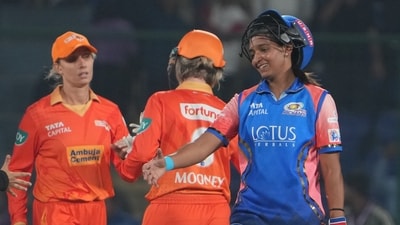 Mumbai Indians batter Harmanpreet Kaur exchanges greetings with Gujarat Giants players (PTI) Mumbai Indians batter Harmanpreet Kaur exchanges greetings with Gujarat Giants players (PTI)