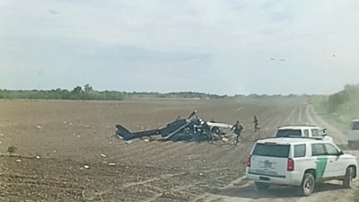 A view from inside a vehicle shows emergency services personnel responding to a helicopter crash near La Grulla, Texas, United States, March 8, 2024 in this screen grab obtained from social media video. A.C./via REUTERS (A.C. via REUTERS)