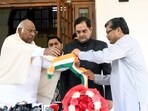 Newly-joined Congress member Brijendra Singh with party president Mallikarjun Kharge and party general secretary Mukul Wasnik, at his residence, in New Delhi on Sunday. (ANI)