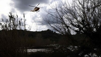 A helicopter takes part in searching operations of seven missing persons near the Gardon river in Russan, following heavy rain over south-eastern France. (AFP) A helicopter takes part in searching operations of seven missing persons near the Gardon river in Russan, following heavy rain over south-eastern France. (AFP)