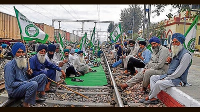 Farmers protesting on railway tracks in Ludhiana on Sunday. (Manish/HT Photo)