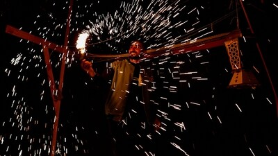 A man waves a homemade sparkler firework as displaced Palestinians prepare their tents for Ramadan. (REUTERS)