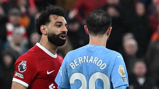 Liverpool's Egyptian striker #11 Mohamed Salah (L) remonstrates with Manchester City's Portuguese midfielder #20 Bernardo Silva (AFP)