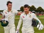 Australia's Alex Carey, right, and Pat Cummins walk from the field after defeating New Zealand . Australia's Alex Carey, right, and Pat Cummins walk from the field after defeating New Zealand .