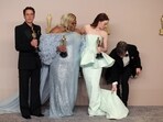 Cillian Murphy, winner of the Best Actor Oscar for "Oppenheimer", adjusts the dress of Emma Stone, winner of the Best Actress Oscar for "Poor Things", as they pose with Da'Vine Joy Randolph, Best Supporting Actress Oscar winner for "The Holdovers", and Robert Downey Jr., Best Supporting Actor Oscar winner for “Oppenheimer”.