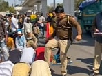 Delhi A police sub-inspector kicks men who were offering namaz on the road in Inderlok area, in New Delhi, Friday, March, 8, 2024.