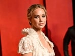 Jennifer Lawrence arrives at the Vanity Fair Oscar Party. She made a quick outfit change after presenting the Best Actress Award to her friend Emma Stone at the Oscars ceremony.