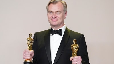 Christopher Nolan poses in the press room with the awards for best director and best picture for "Oppenheimer" at the Oscars on Sunday, March 10, 2024, at the Dolby Theatre in Los Angeles. (Photo by Jordan Strauss/Invision/AP) (Jordan Strauss/Invision/AP)
