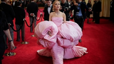 Ariana Grande attended the Oscars 2024 in a pink voluminous gown that seemingly gave a nod to her upcoming role as the good witch in the movie Wicked. The custom Giambattista Valli Haute Couture ensemble featured voluminous sleeves, a gathered design on the form-fitted dress, and a trailing train. Retro-styled blonde hairdo, striking glam, and diamond jewels completed the look. (John Locher/Invision/AP) Ariana Grande attended the Oscars 2024 in a pink voluminous gown that seemingly gave a nod to her upcoming role as the good witch in the movie Wicked. The custom Giambattista Valli Haute Couture ensemble featured voluminous sleeves, a gathered design on the form-fitted dress, and a trailing train. Retro-styled blonde hairdo, striking glam, and diamond jewels completed the look. (John Locher/Invision/AP)