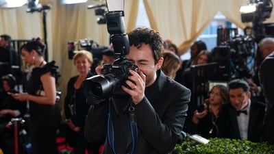 Ramy Youssef pretended to be a red carpet photographer and playfully took hold of a camera. (AP) Ramy Youssef pretended to be a red carpet photographer and playfully took hold of a camera. (AP)