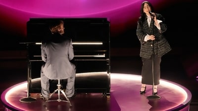 Finneas, left, and Billie Eilish perform What Was I Made For? from Barbieb during the Oscars. Billie Eilish channelled Clueless's Cher Horowitz-style schoolgirl aesthetic on the Oscars 2024 red carpet in a head-to-toe Chanel look. She wore a tweed skirt, black blazer, white skirt, white socks and patent leather Mary Jane pumps for the red carpet. (Chris Pizzello/Invision/AP) Finneas, left, and Billie Eilish perform What Was I Made For? from Barbieb during the Oscars. Billie Eilish channelled Clueless's Cher Horowitz-style schoolgirl aesthetic on the Oscars 2024 red carpet in a head-to-toe Chanel look. She wore a tweed skirt, black blazer, white skirt, white socks and patent leather Mary Jane pumps for the red carpet. (Chris Pizzello/Invision/AP)