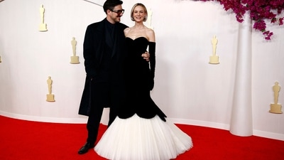 Carey Mulligan graced the 2024 Oscars red carpet in a stunning black mermaid dress with a scalloped hem over white tulle. Her ensemble is a recreation of a classic Balenciaga design from 1951. She accessorized the ensemble with diamond earrings and elbow-length black gloves.&nbsp; (REUTERS)