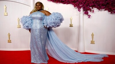 Da'Vine Joy Randolph, who won the Best Supporting Actress Award for The Holdovers, wore an ice-blue sequinned gown for her Oscars 2024 debut. The custom Louis Vuitton dress features sequin embellishments, a halter neckline, exaggerated ruffle sleeves, and a tulle train. To top off the look, she channelled Old Hollywood glamour with a wavy, blonde side part and added an extra touch of shimmer with sparkly drop earrings and a glossy lip.&nbsp; (REUTERS)