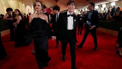 Cillian Murphy and Yvonne McGuinness arrived at the Oscars 2024 red carpet hand-in-hand. The actor, nominated in the Best Actor category for his role in Oppenheimer, wore a sleek black tuxedo, He wore a black blazer featuring satin notch lapel, and styled it with a white shirt, black silk bow tie, and high-waisted black pants. A luxurious watch, a gold brooch, a messy hairdo, and black dress shoes completed his outfit.&nbsp; (REUTERS)