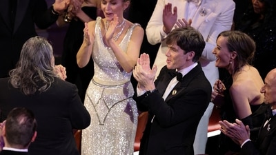 On the red carpet, Emily Blunt made her way over to greet Oppenheimer director Christopher Nolan and producer Emma Thomas.&nbsp; (REUTERS)