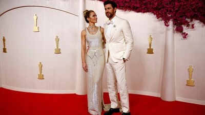 Emily Blunt arrived at the Oscars with her husband, John Krasinski. Nominated for the Best Supporting Actress category for Oppenheimer, Emily wore a custom Schiaparelli gown. The head-turning comes with a form-fitted bodice, pearl-white sequins, silver beads, and a train on the back. She styled the ensemble with a layered diamond necklace, a messy updo, and glowing glam.&nbsp; (REUTERS)