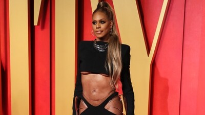 Laverne Cox made heads turn at the after-party in a Mugler black gown featuring full-length sleeves, padded shoulders, an under-bust revealing cropped hem, side cut-outs on the waist, a form-fitted skirt, floor-length hem, and see-through attachments on the hips.&nbsp; (REUTERS)