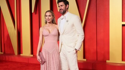 Emily Blunt arrived with her husband, John Krasinski, at the Vanity Fair Oscars after-party red carpet. The Oscar-nominated actress chose a Dolce &amp; Gabbana lace-embroidered muted pink gown featuring strappy shoulders, a plunging neckline, a fitted bodice, and a flowy floor-length skirt. She styled the dress with a clutch, dainty earrings, rings, centre-parted open locks, and minimal glam.&nbsp; (REUTERS)