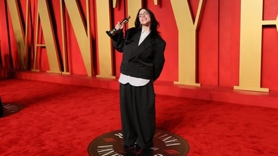 Billie Eilish, who became the youngest two-time Best Song winner and broke an 87-year-old record, changed from school girl aesthetic in a relaxed fit double-breasted crop blazer, a button-down curved hem shirt, and baggy pants. Glasses, earrings, and chunky boots completed the accessories with the ensemble.&nbsp; (REUTERS)