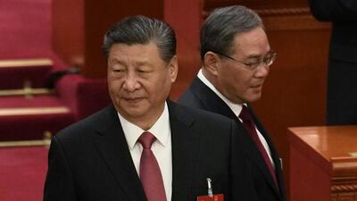 Chinese Premier Li Qiang (right) passes by President Xi Jinping as they attend the closing session of the National People's Congress held at the Great Hall of the People in Beijing, on Monday (AP) Chinese Premier Li Qiang (right) passes by President Xi Jinping as they attend the closing session of the National People's Congress held at the Great Hall of the People in Beijing, on Monday (AP)