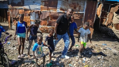 FILE - Jimmy Cherizier, a former elite police officer known as Barbecue who now runs a gang federation, walks hand in hand with children as he visits La Saline district of Port-au-Prince, Haiti, Jan. 24, 2023. Internationally, Cherizier is known as Haiti's most powerful and feared gang leader, sanctioned by the United Nations for "serious human rights abuses," and the man behind a fuel blockade that brought the Caribbean nation to its knees in late 2022. (AP Photo/Odelyn Joseph, File) (AP) FILE - Jimmy Cherizier, a former elite police officer known as Barbecue who now runs a gang federation, walks hand in hand with children as he visits La Saline district of Port-au-Prince, Haiti, Jan. 24, 2023. Internationally, Cherizier is known as Haiti's most powerful and feared gang leader, sanctioned by the United Nations for "serious human rights abuses," and the man behind a fuel blockade that brought the Caribbean nation to its knees in late 2022. (AP Photo/Odelyn Joseph, File) (AP)
