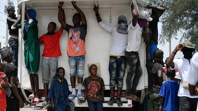 FILE - Youths and members of the gang led by Jimmy Cherizier, alias Barbecue, a former police officer who heads a gang coalition hang out during a march to demand justice for slain Haitian President Jovenel Moise, in the La Saline neighborhood of Port-au-Prince, Haiti, July 26, 2021. (AP Photo/Matias Delacroix, File) (AP) FILE - Youths and members of the gang led by Jimmy Cherizier, alias Barbecue, a former police officer who heads a gang coalition hang out during a march to demand justice for slain Haitian President Jovenel Moise, in the La Saline neighborhood of Port-au-Prince, Haiti, July 26, 2021. (AP Photo/Matias Delacroix, File) (AP)