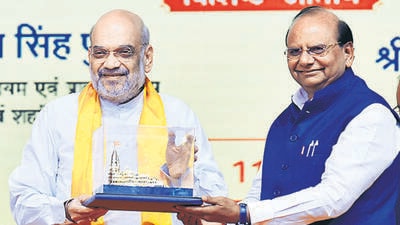 Home minister Amit Shah is felicitated by LG VK Saxena at the event in Dwarka on Monday. (ANI) Home minister Amit Shah is felicitated by LG VK Saxena at the event in Dwarka on Monday. (ANI)