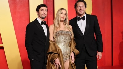 Margot Robbie attended the Vanity Fair Oscars after-party with her husband, Tom Ackerley. The Barbie actor went pantless in a Mugler Spring-Summer 1996 look. She wore a gilded copper bodysuit and layered it with a long jacket featuring an open front and full-length sleeves. Gold pumps, loose waves, mauve lip shade, mascara on the lashes, feathered brows, and rouge on the cheekbones complemented her OOTD.&nbsp; (REUTERS)