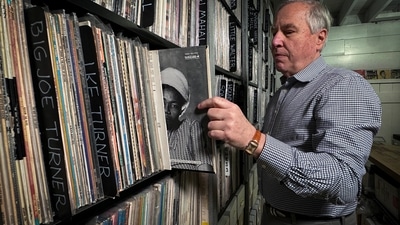 Bob George, Co-Founder and Director of the Archive of Contemporary Music, one of the largest vinyl record collections in the world that is seeking a new home, looks at records during an interview with Reuters.