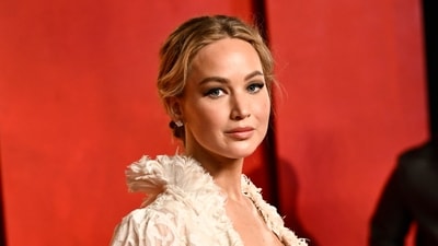 Jennifer Lawrence arrives at the Vanity Fair Oscar Party. She made a quick outfit change after presenting the Best Actress Award to her friend Emma Stone at the Oscars ceremony. (Evan Agostini/Invision/AP)