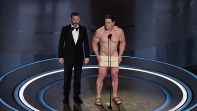 Oscars 2024: John Cena (right) on stage with host Jimmy Kimmel (left) during the presentation of the award for Best Costume Design at the 96th Academy Awards in Hollywood, California. (REUTERS)